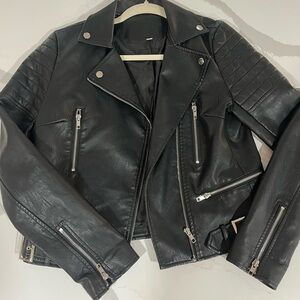 Black faux leather jacket with zipper detailing and quilted lining. Size medium
